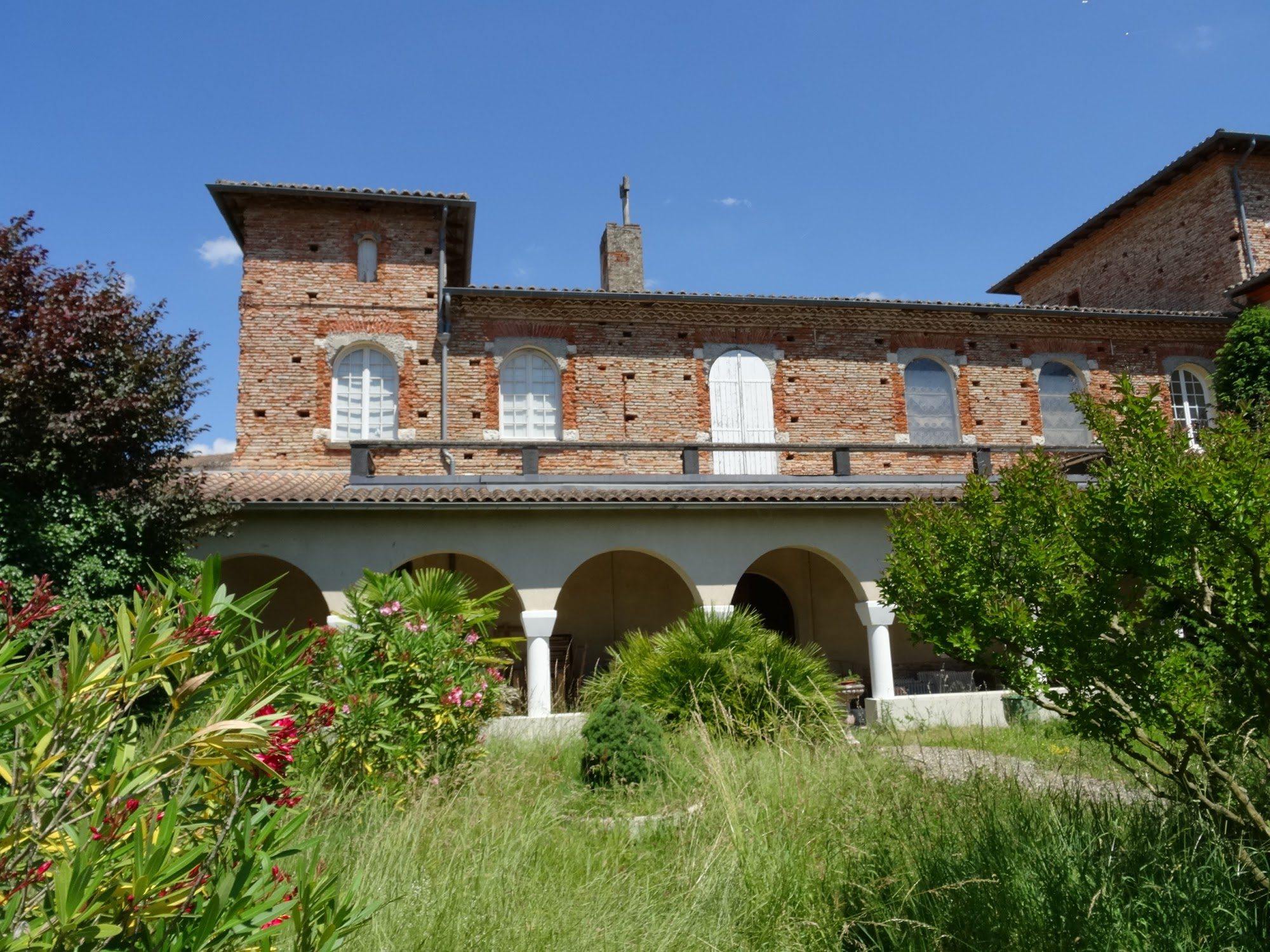 The garden front of the abbey, brick ranges with regular windows.